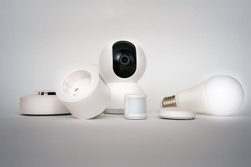 Smart-home hub and connected devices on a shelf with a smartphone app - illustrating the Matter standard for cross-platform smart-home devices