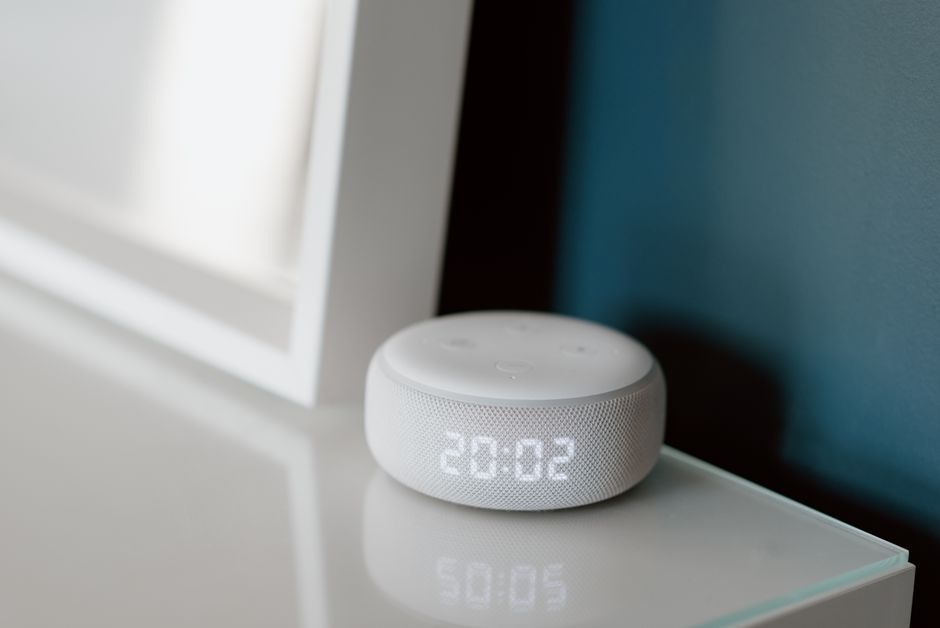 Compact spherical smart speaker on a side table