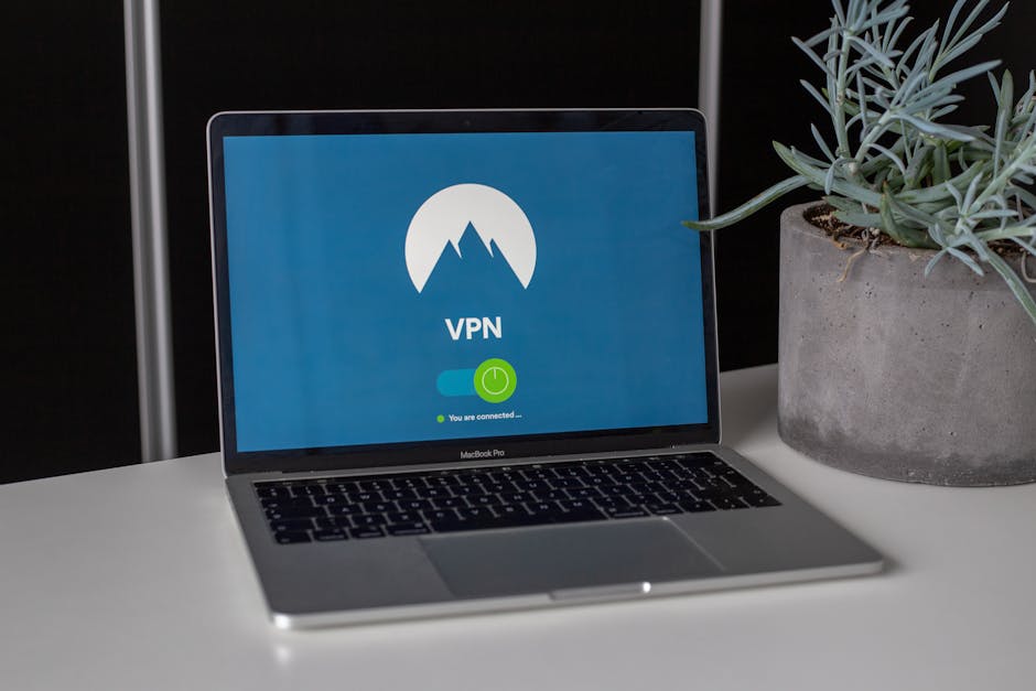 Laptop on a desk with a padlock-and-key privacy icon, illustrating a VPN connection