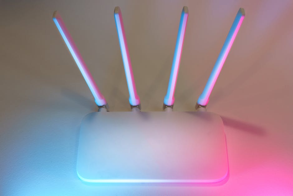White wireless router with four antennas on a desk
